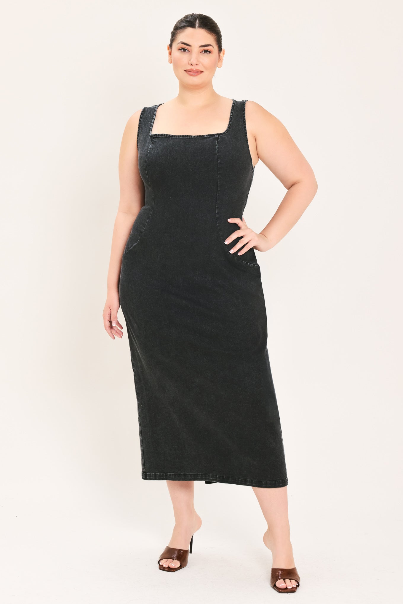 A woman modeling a black sleeveless midi dress with a square neckline | Plus Curve Flying Tomato