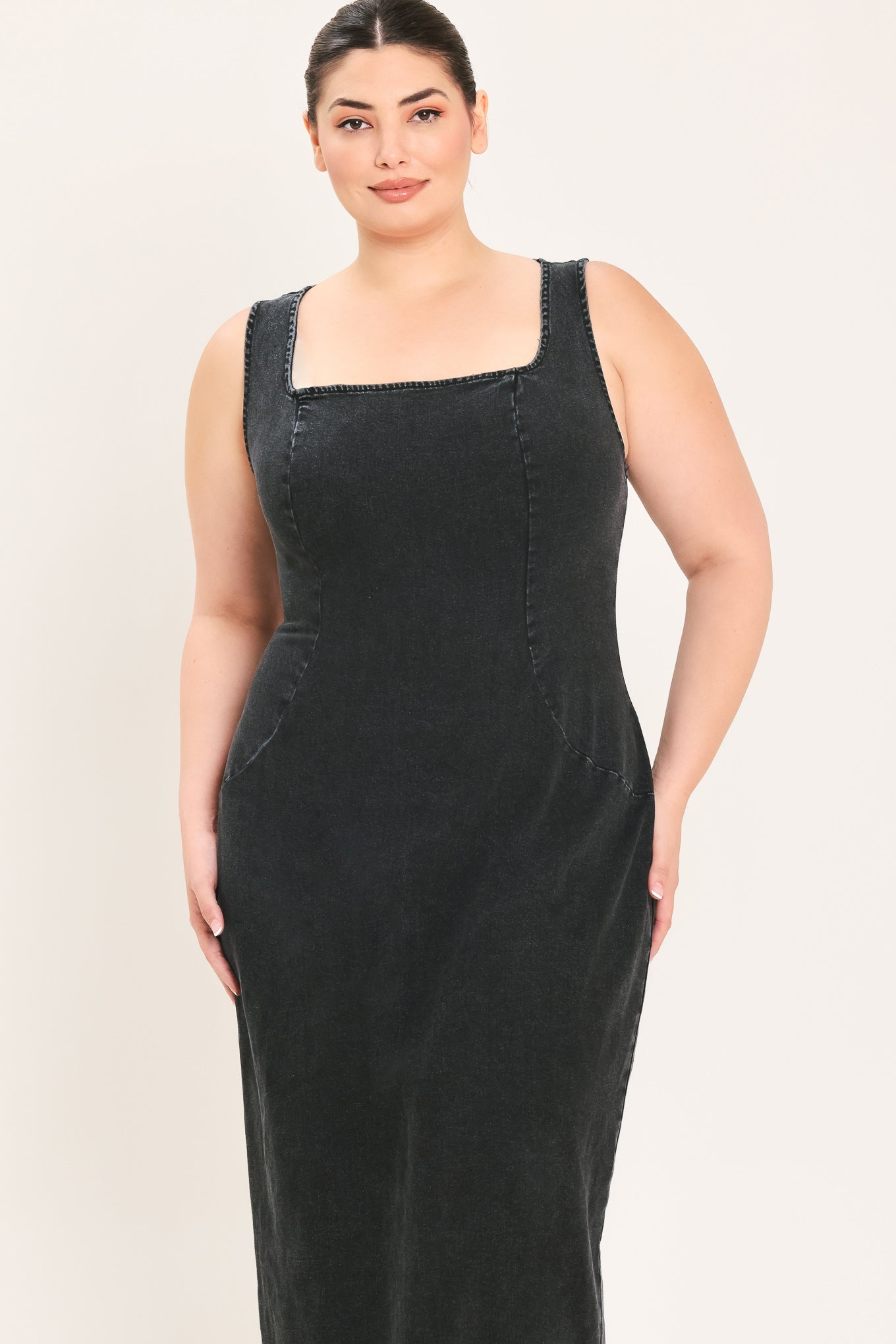 A woman modeling a black sleeveless midi dress with a square neckline | Plus Curve Flying Tomato