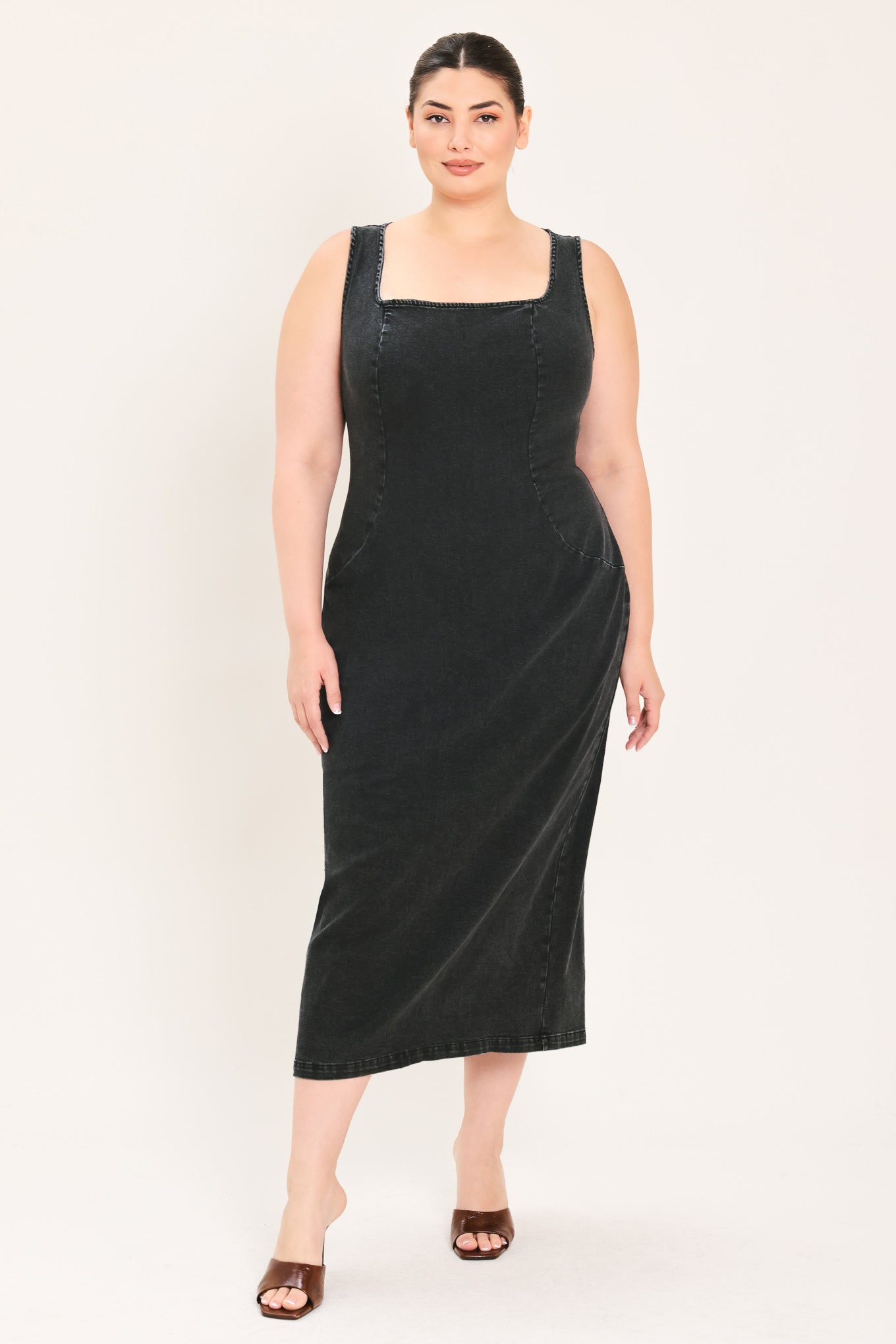 A woman modeling a black sleeveless midi dress with a square neckline | Plus Curve Flying Tomato