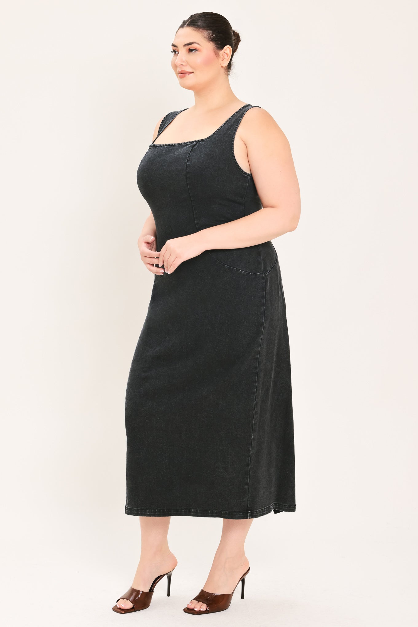 A woman modeling a black sleeveless midi dress with a square neckline | Plus Curve Flying Tomato