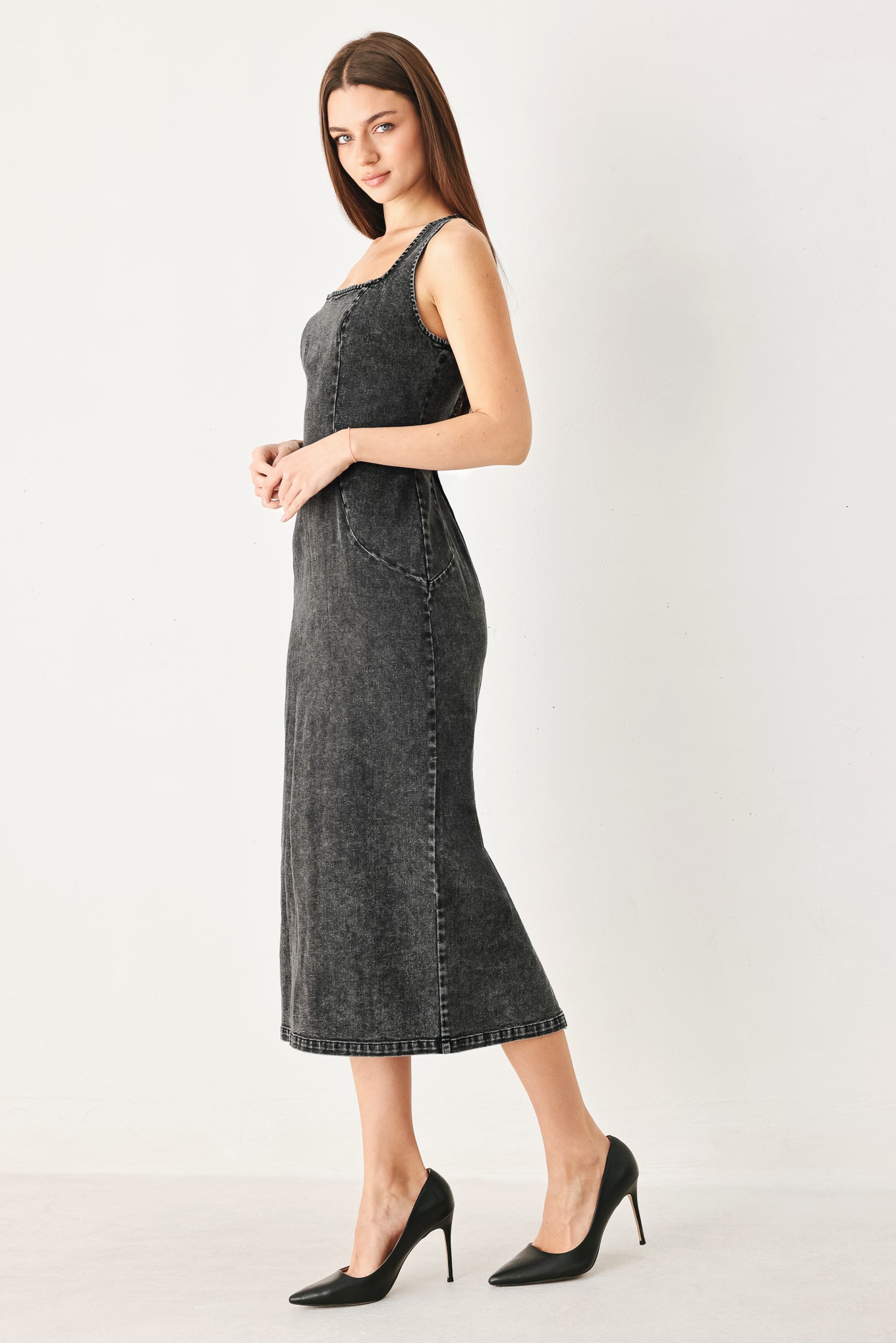 Woman wearing a washed black denim midi dress featuring square neckline, sleeveless and back zipper closure | FREEMARKET