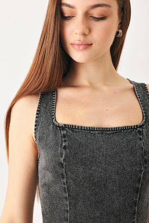 Woman wearing a washed black denim midi dress featuring square neckline, sleeveless and back zipper closure | FREEMARKET