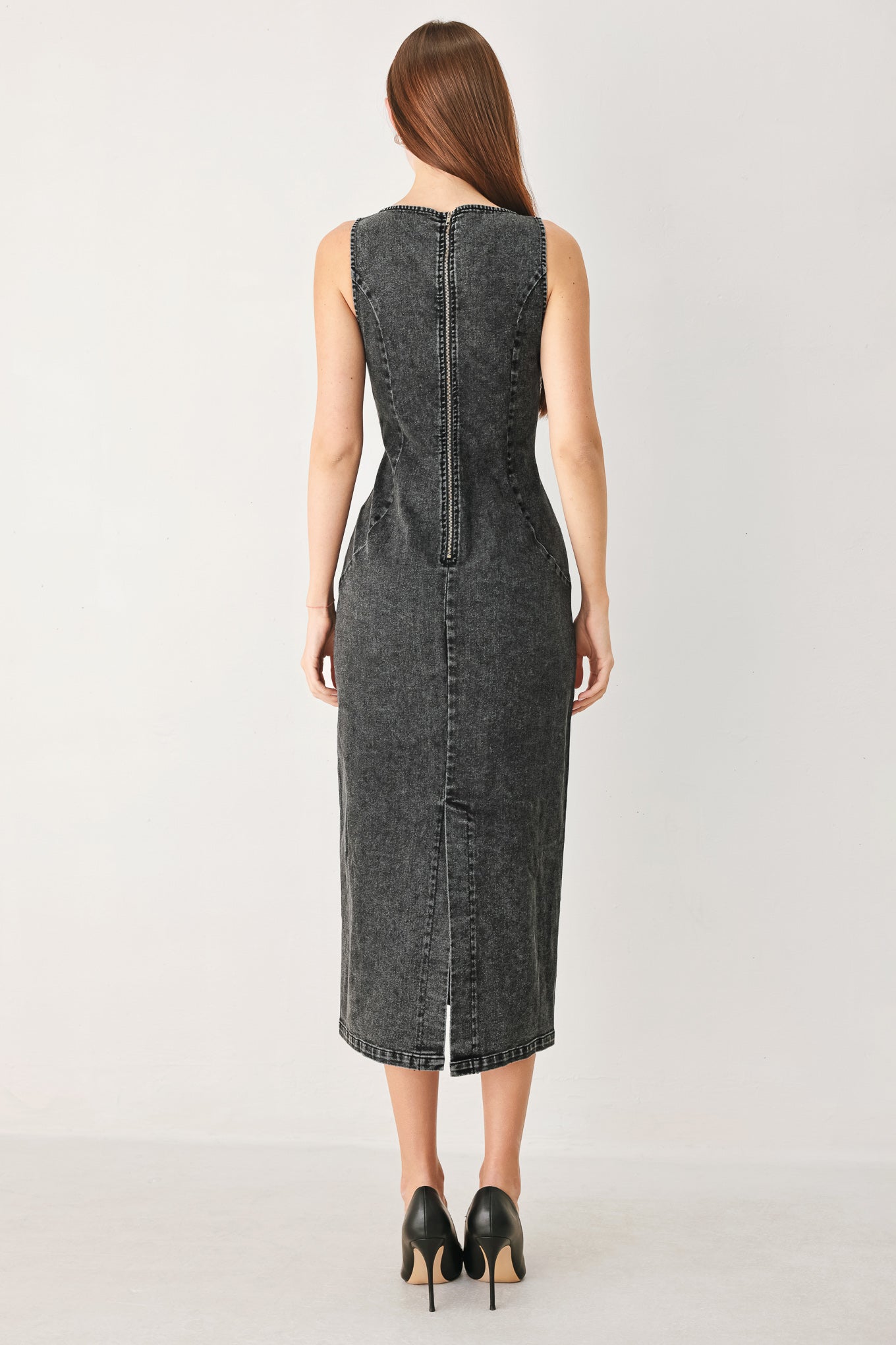 Woman wearing a washed black denim midi dress featuring square neckline, sleeveless and back zipper closure | FREEMARKET
