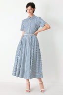 Woman wearing a denim blue and white striped midi shirt dress with self belt and full skirt | FREEMARKET