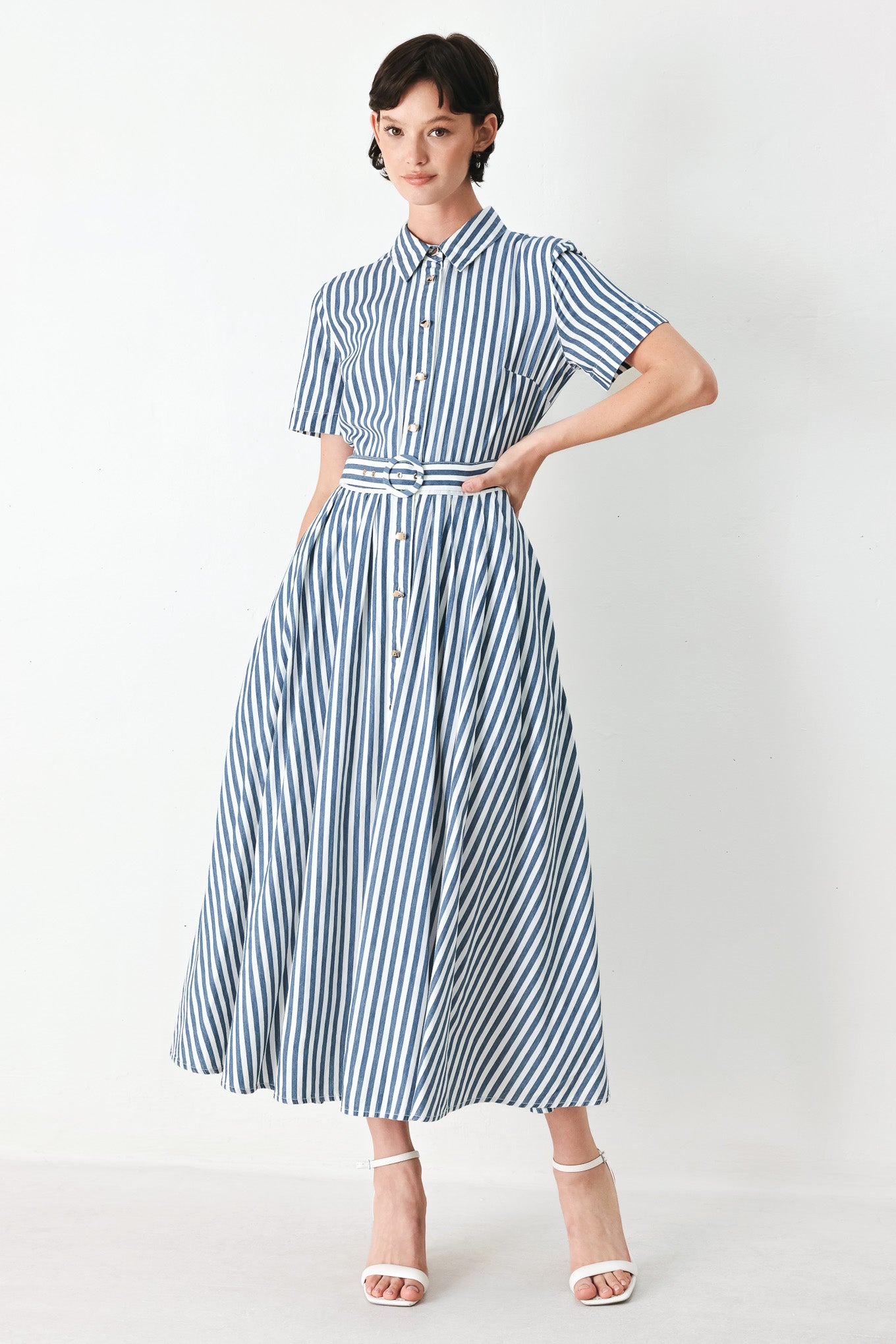 Woman wearing a denim blue and white striped midi shirt dress with self belt and full skirt | FREEMARKET