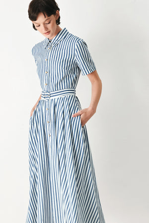 Woman wearing a denim blue and white striped midi shirt dress with self belt and full skirt | FREEMARKET