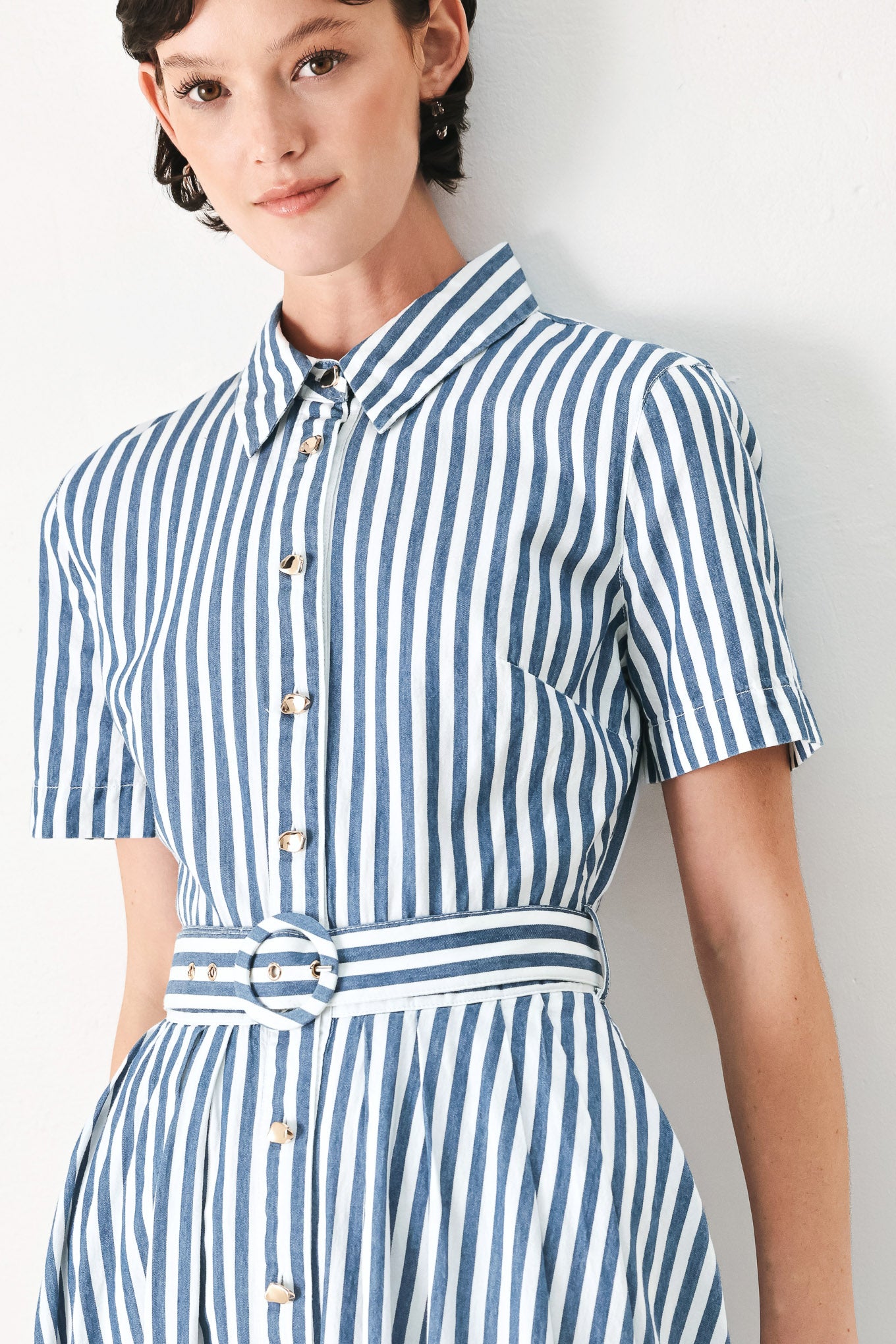 Woman wearing a denim blue and white striped midi shirt dress with self belt and full skirt | FREEMARKET