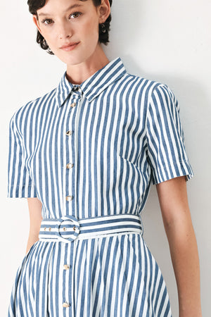 Woman wearing a denim blue and white striped midi shirt dress with self belt and full skirt | FREEMARKET