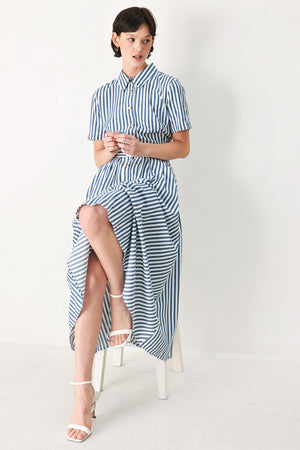 Woman wearing a denim blue and white striped midi shirt dress with self belt and full skirt | FREEMARKET