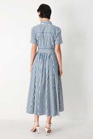 Woman wearing a denim blue and white striped midi shirt dress with self belt and full skirt | FREEMARKET
