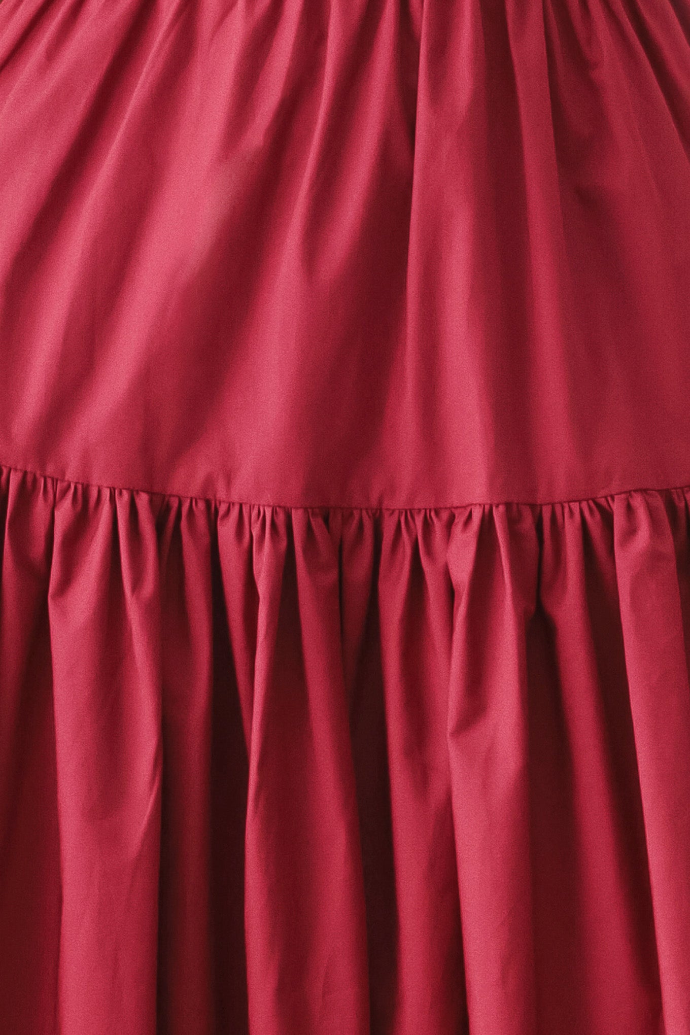 Woman wearing a burgundy red midi dress featuring straight neckline, straps, front button detail, single tier and back zipper | FREEMARKET