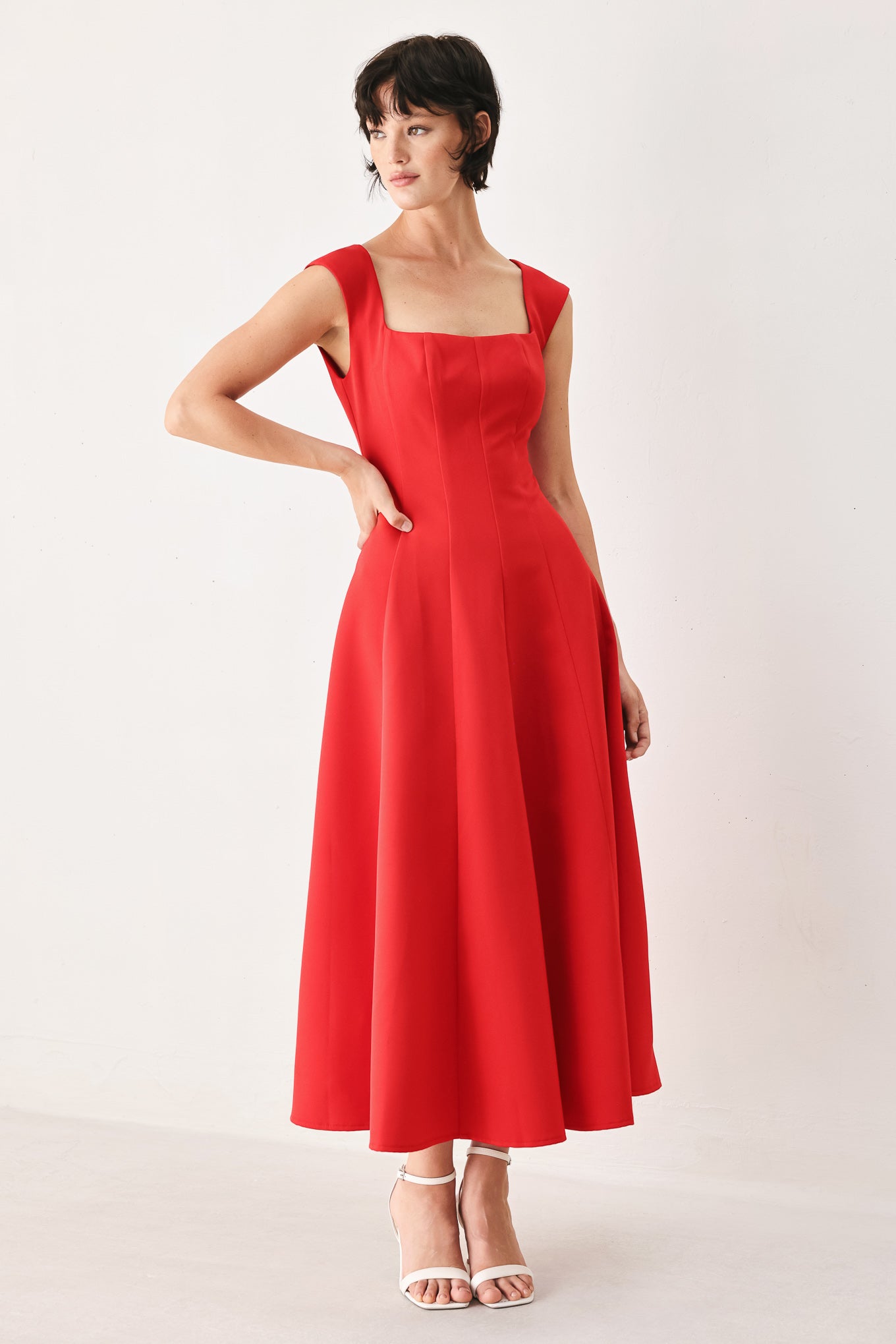 Woman wearing a red midi dress featuring square neckline, cap sleeve, circle skirt and back zipper closure | FREEMARKET