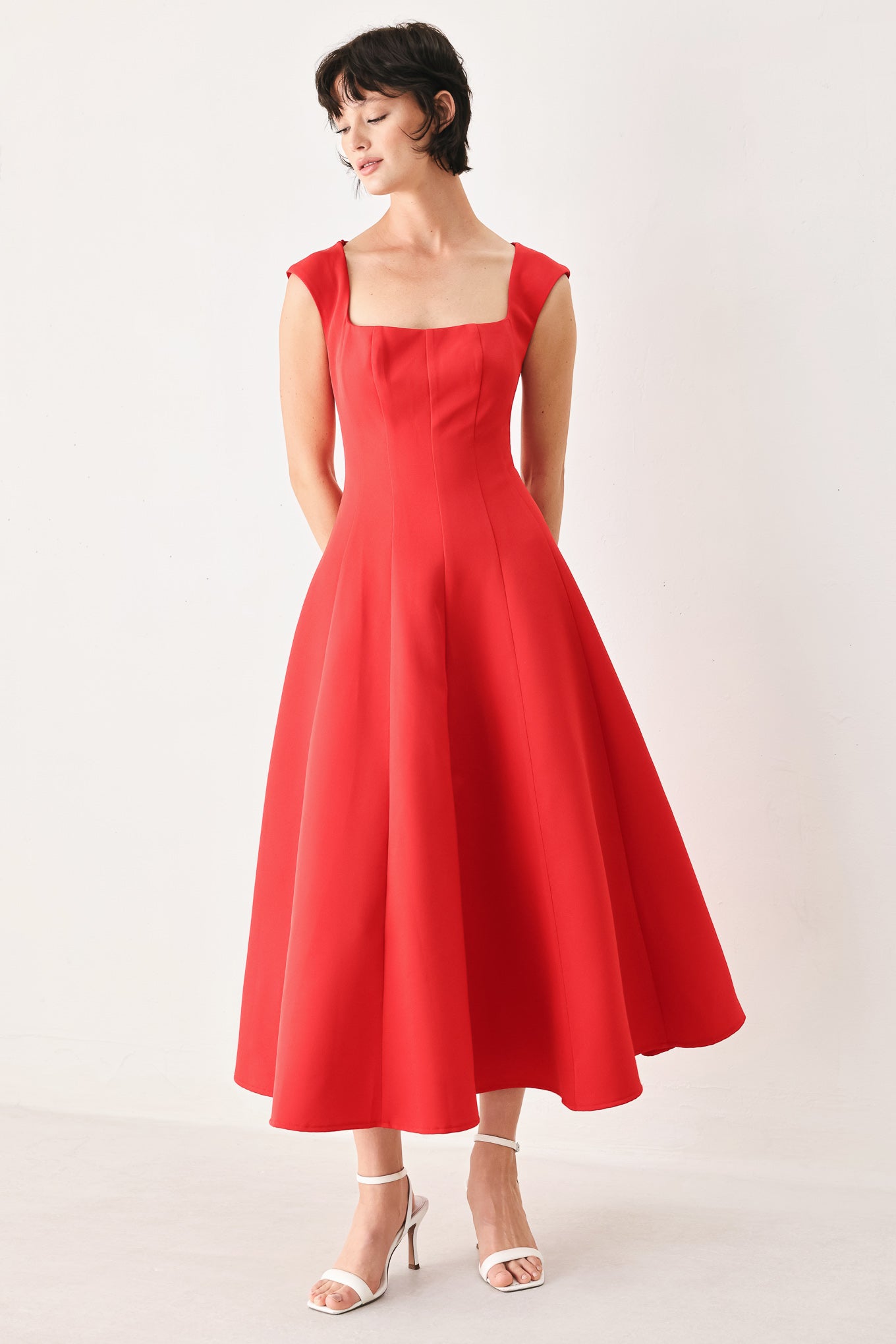 Woman wearing a red midi dress featuring square neckline, cap sleeve, circle skirt and back zipper closure | FREEMARKET