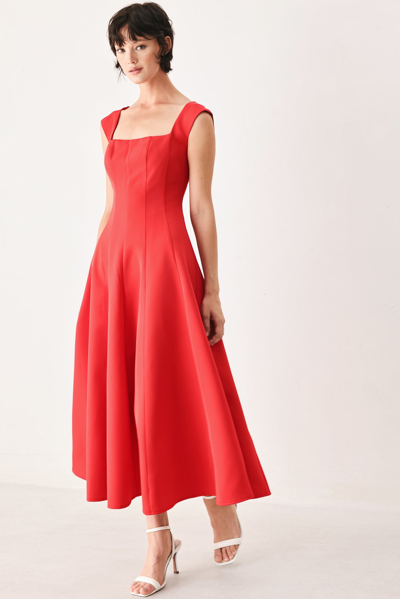 Woman wearing a red midi dress featuring square neckline, cap sleeve, circle skirt and back zipper closure | FREEMARKET