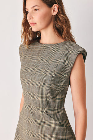 A woman wearing a sleeveless, min gray plaid dress with structured shoulders | FREEMARKET