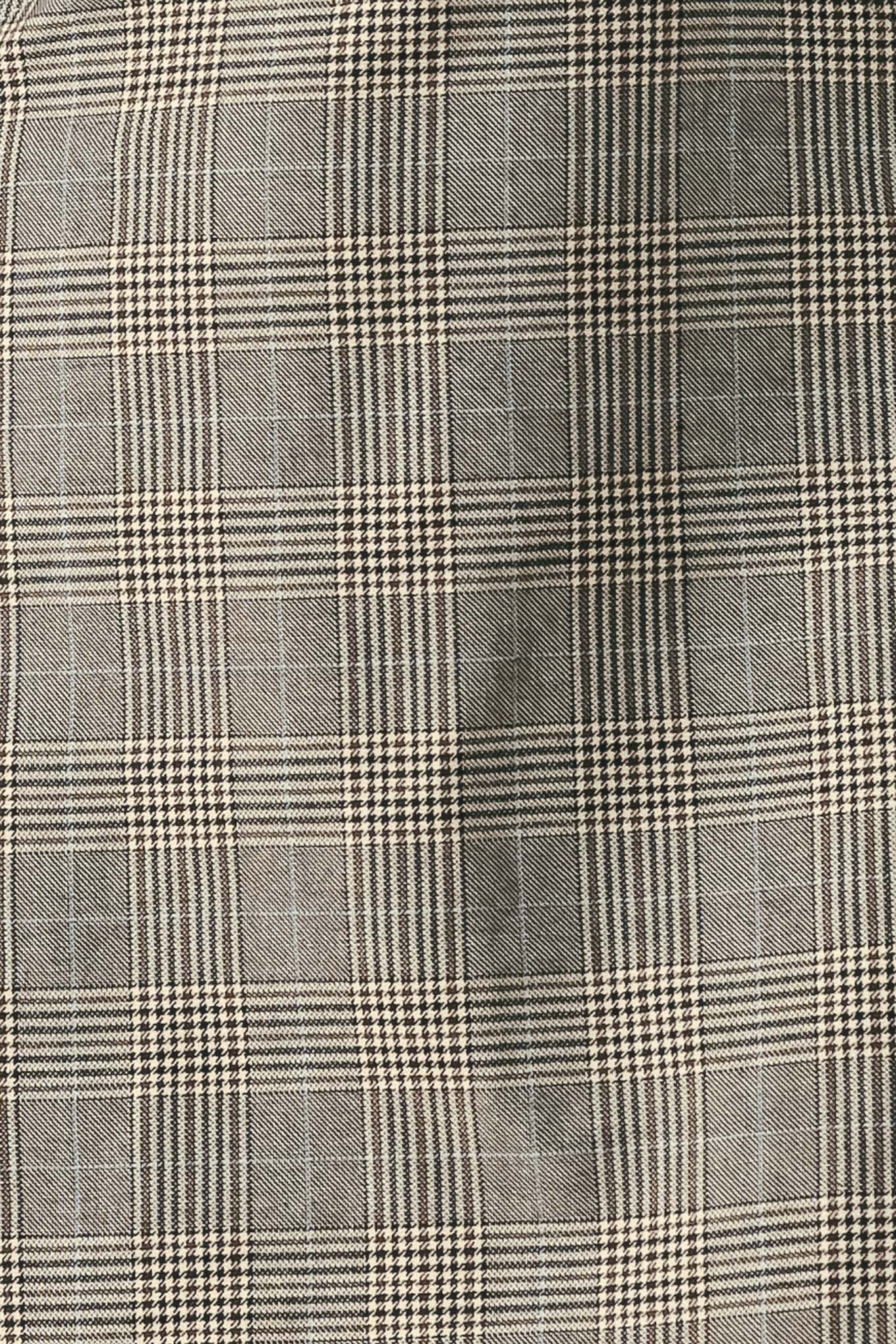 A woman wearing a sleeveless, min gray plaid dress with structured shoulders | FREEMARKET