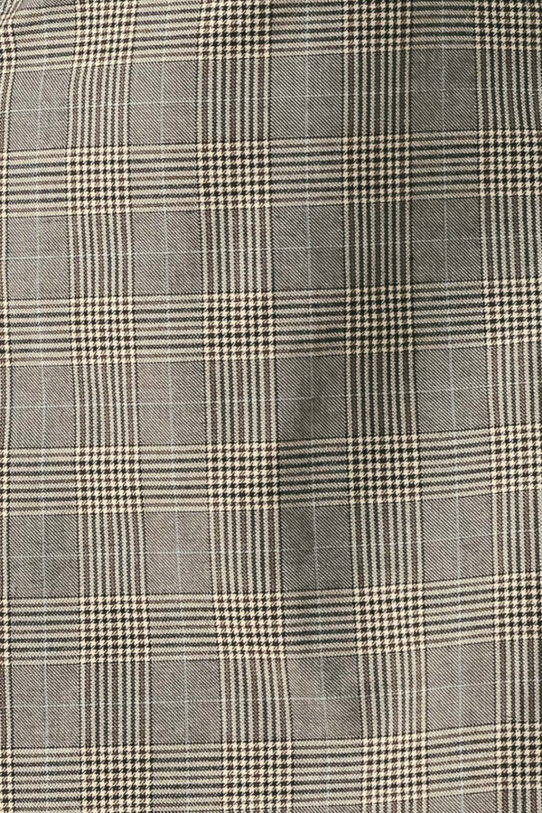 A woman wearing a sleeveless, min gray plaid dress with structured shoulders | FREEMARKET