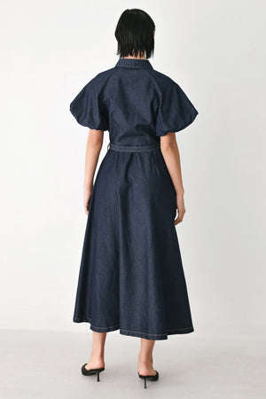 A woman models a dark indigo denim midi shirt dress with short puff sleeves, a pointed collar, and a matching dark belt | FREEMARKET