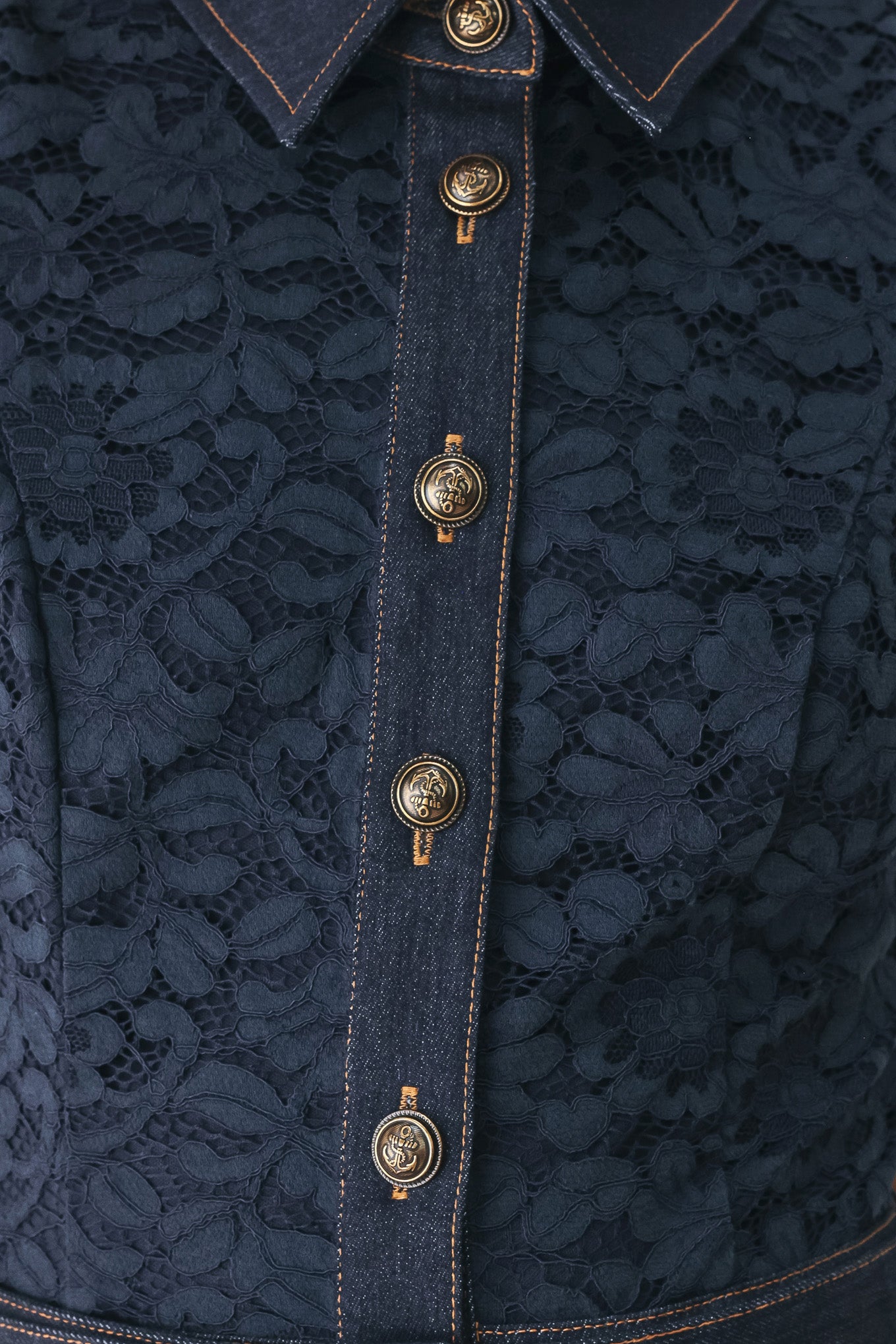 A woman modeling a sleeveless navy midi dress with a lace overlay, button-front bodice, and matching belt | FREEMARKET