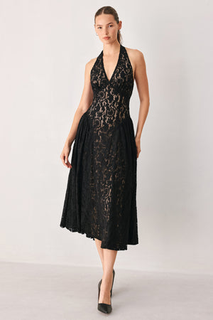 A woman wearing a sleeveless black lace halter midi dress with a deep V-neckline and flared skirt | FREEMARKET