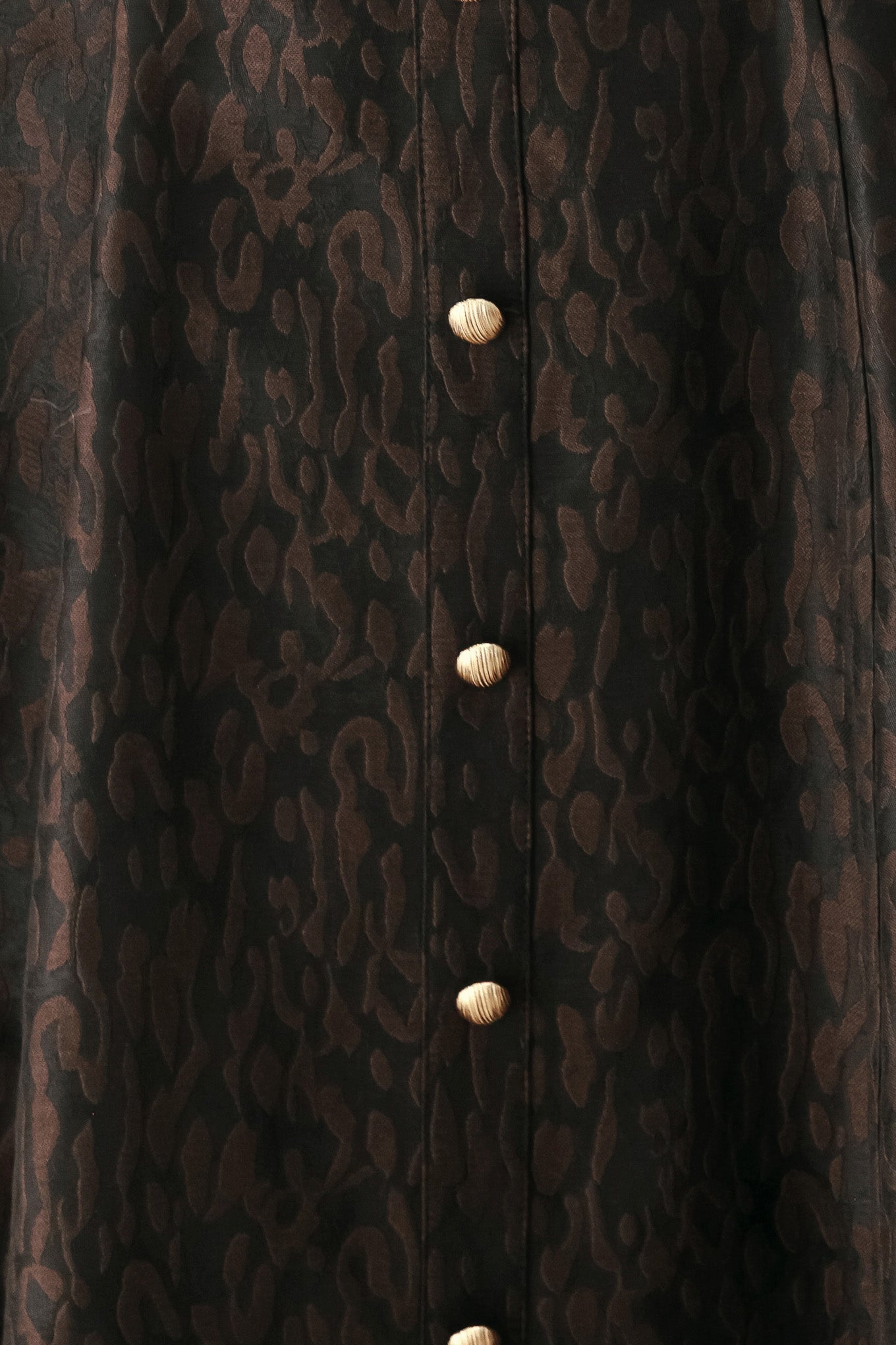 A woman modeling a black midi dress with a textured jacquard leopard pattern, featuring thin spaghetti straps, a sweetheart neckline, a button-down front, and side pockets | FREEMARKET