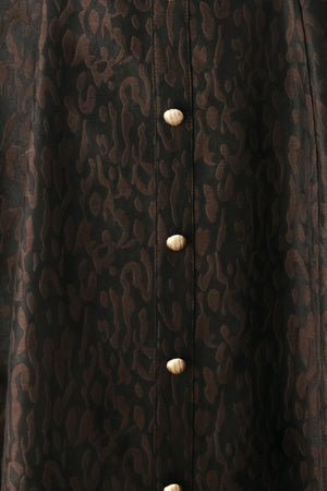A woman modeling a black midi dress with a textured jacquard leopard pattern, featuring thin spaghetti straps, a sweetheart neckline, a button-down front, and side pockets | FREEMARKET