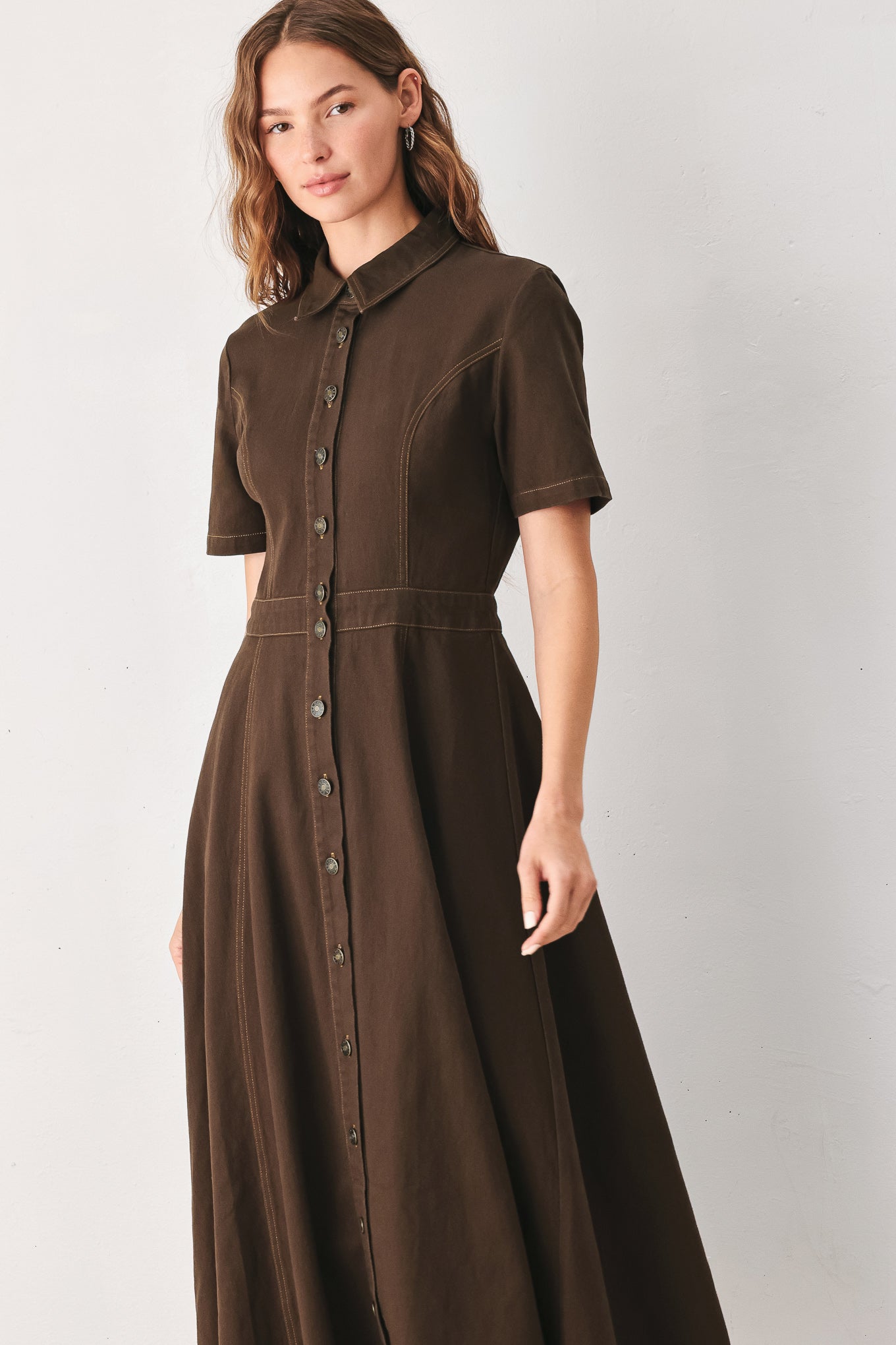 A woman modeling a dark brown short-sleeve midi shirt dress with a button-down front and a defined waist seam | FREEMARKET