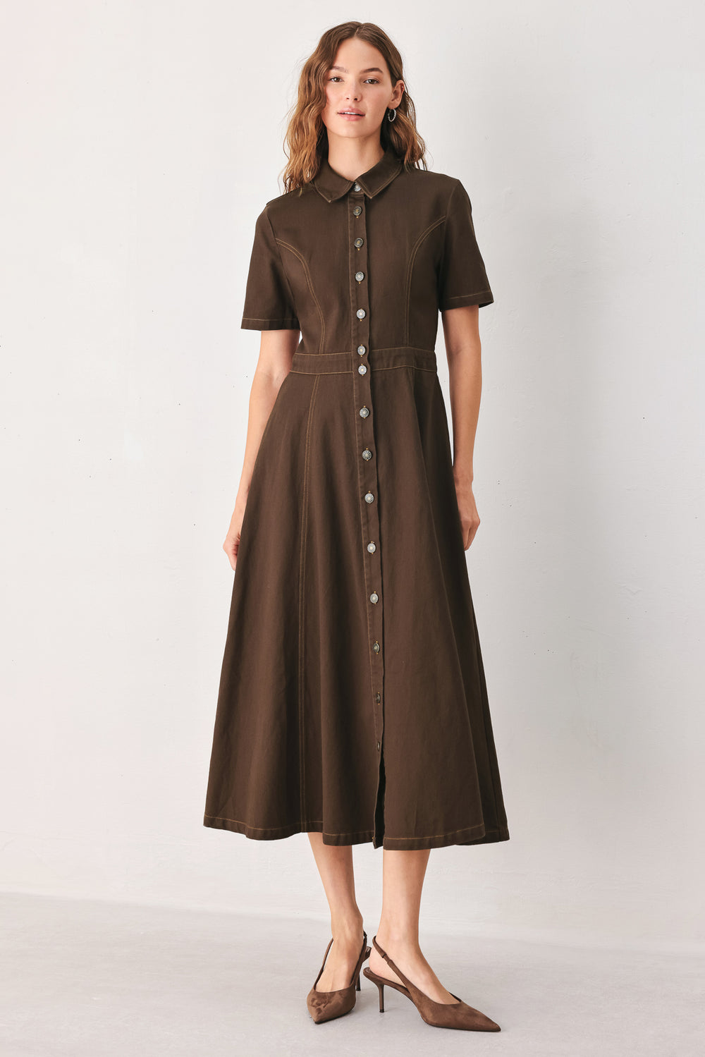 A woman modeling a dark brown short-sleeve midi shirt dress with a button-down front and a defined waist seam | FREEMARKET