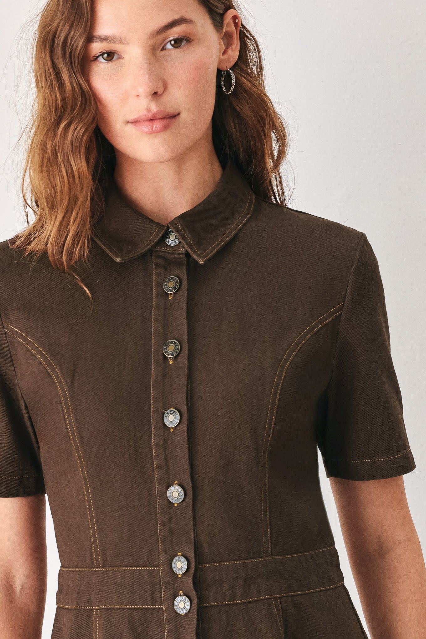 A woman modeling a dark brown short-sleeve midi shirt dress with a button-down front and a defined waist seam | FREEMARKET