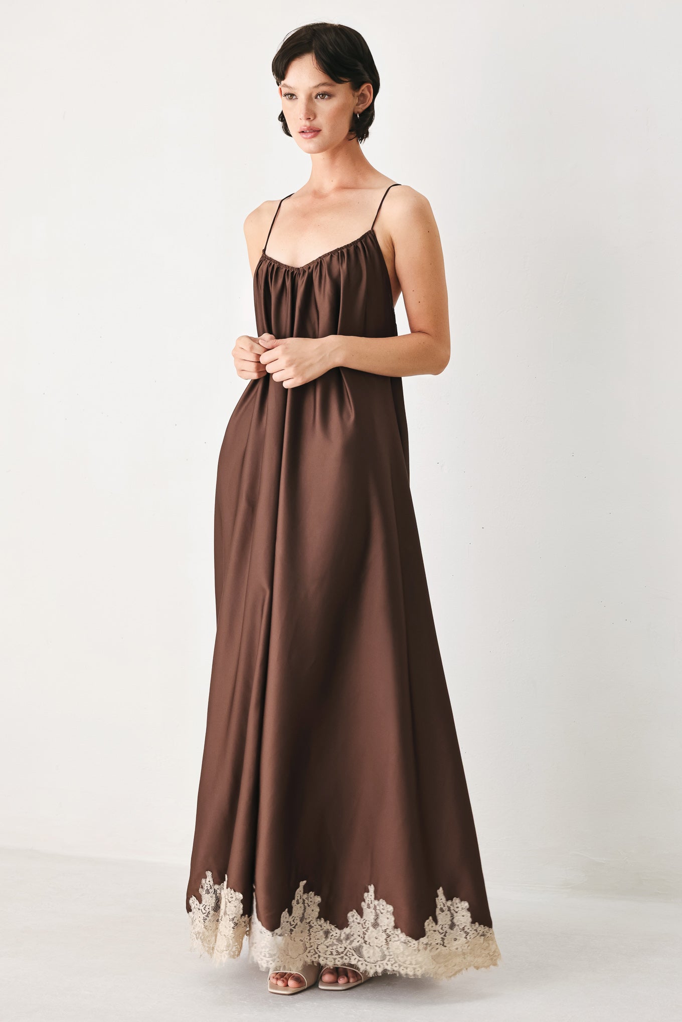 Woman wearing a brown slip dress with cream lace trim | FREEMARKET
