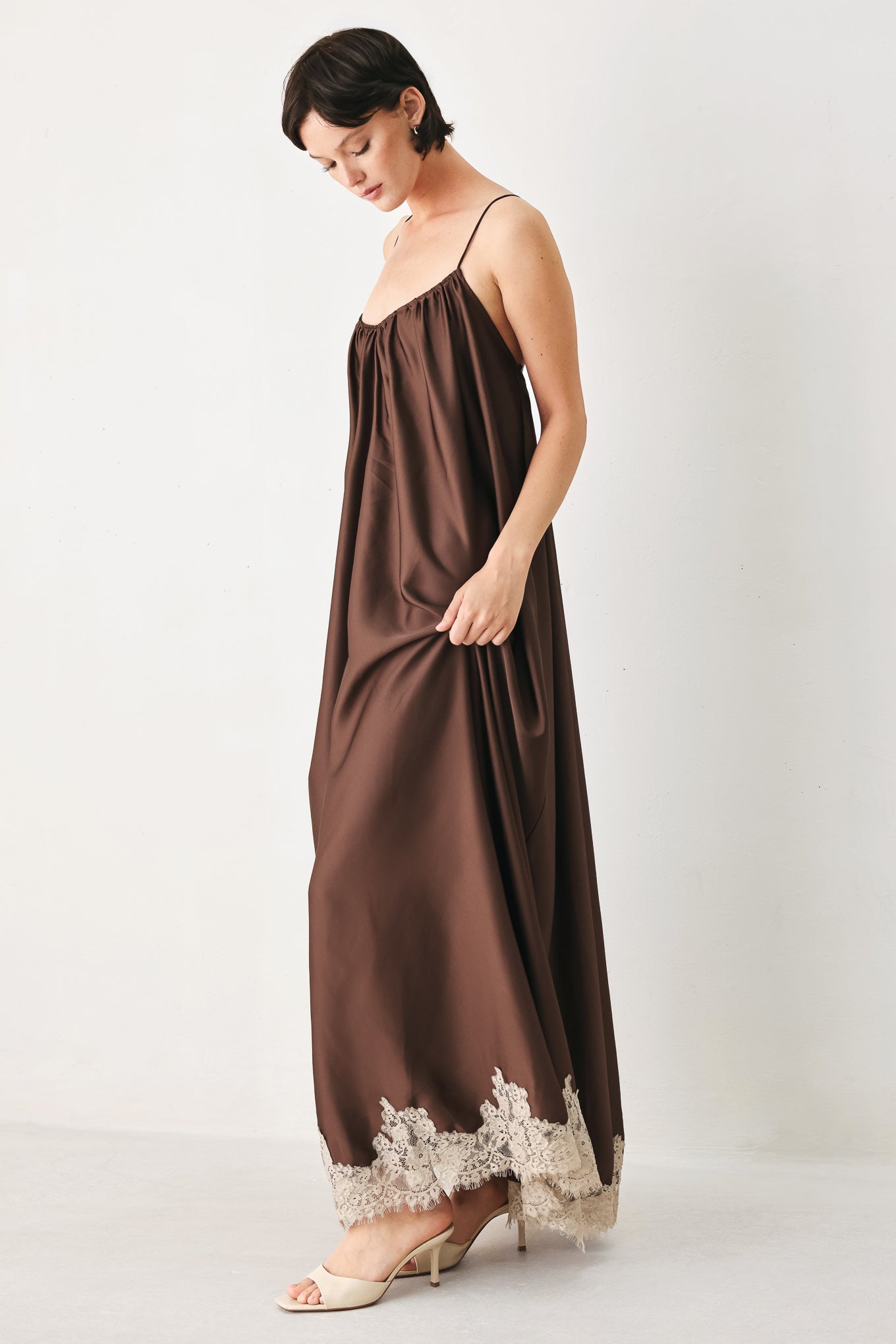 Woman wearing a brown slip dress with cream lace trim | FREEMARKET