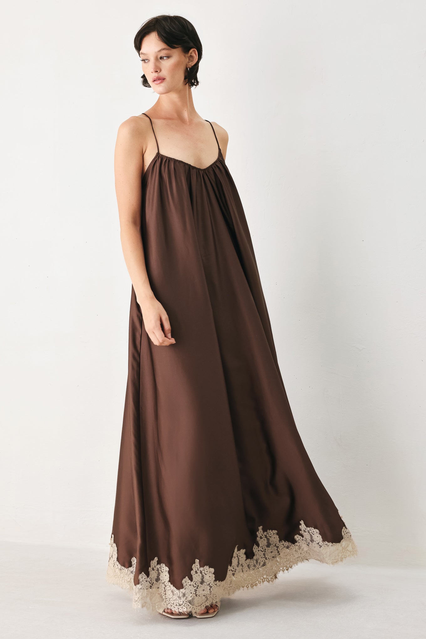 Woman wearing a brown slip dress with cream lace trim | FREEMARKET