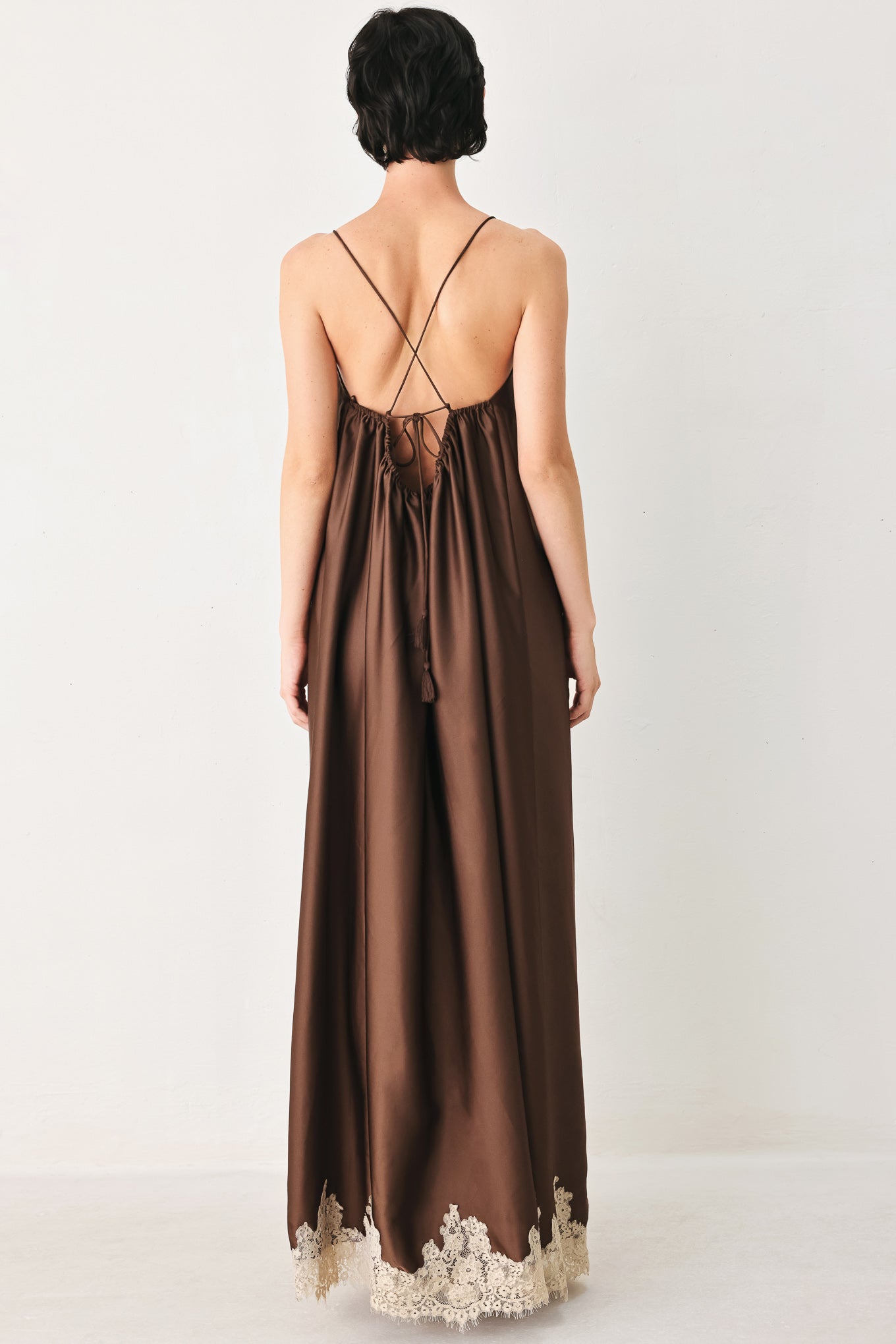 Woman wearing a brown slip dress with cream lace trim | FREEMARKET