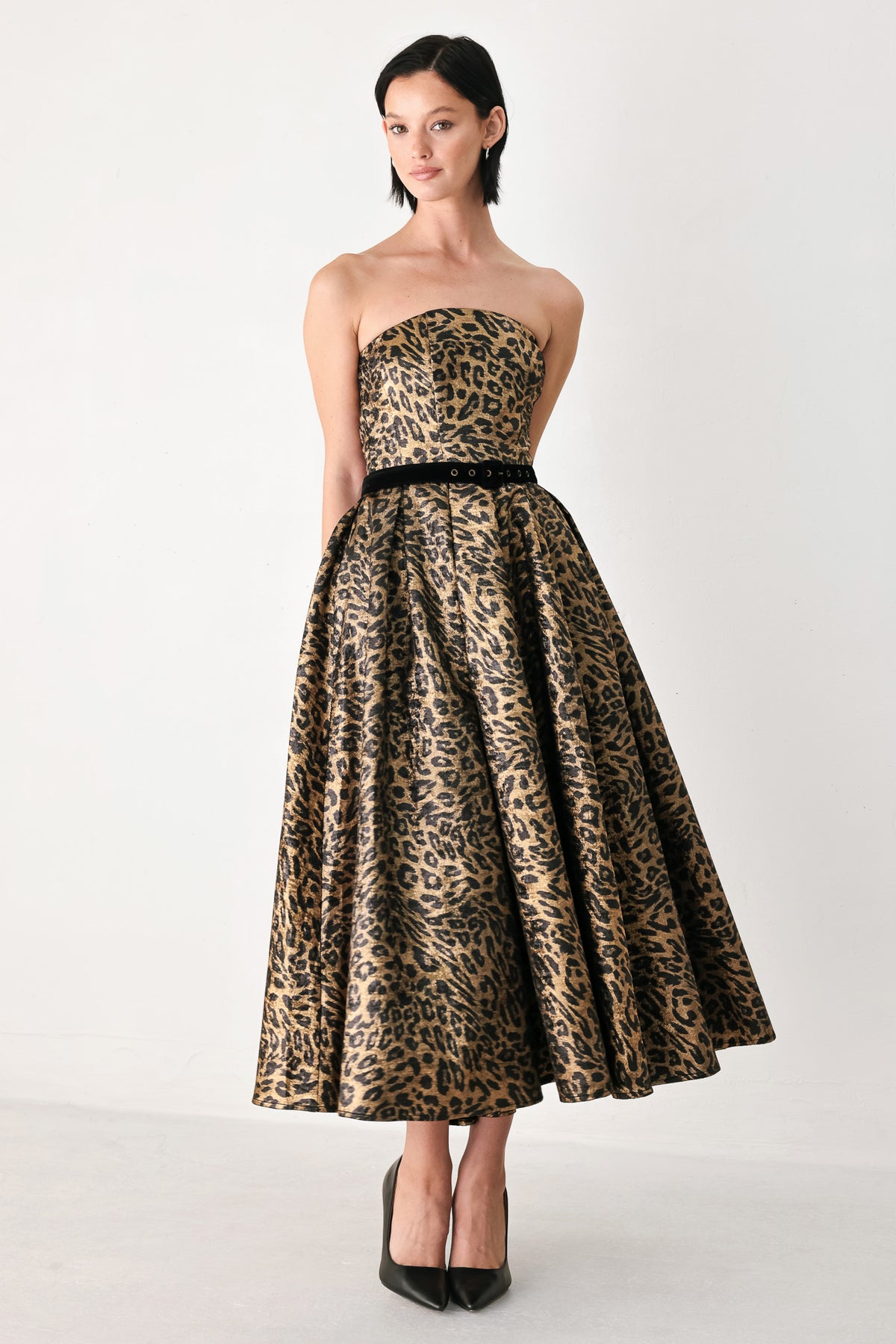 A woman modeling a strapless leopard-print midi dress with a black waist belt | FREEMARKET