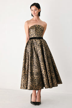 A woman modeling a strapless leopard-print midi dress with a black waist belt | FREEMARKET