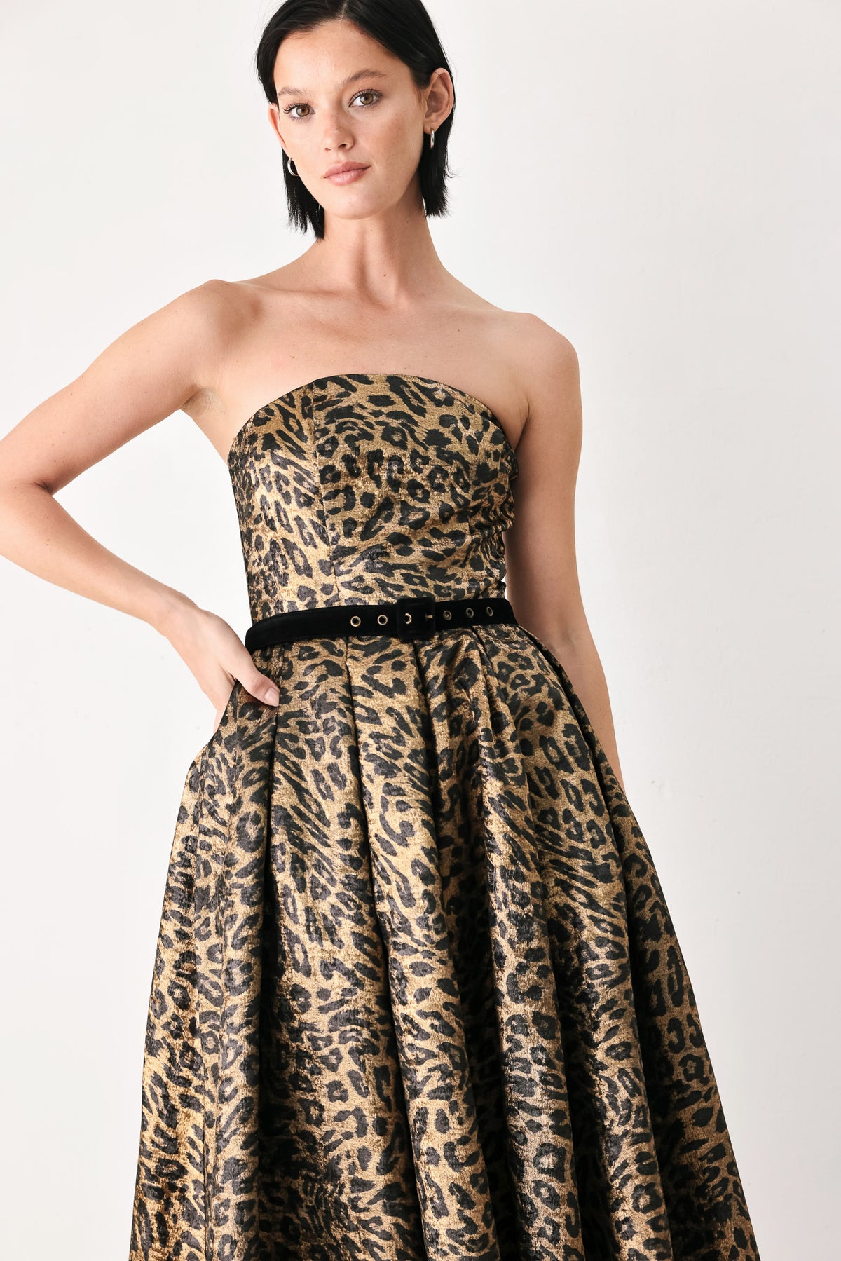 A woman modeling a strapless leopard-print midi dress with a black waist belt | FREEMARKET