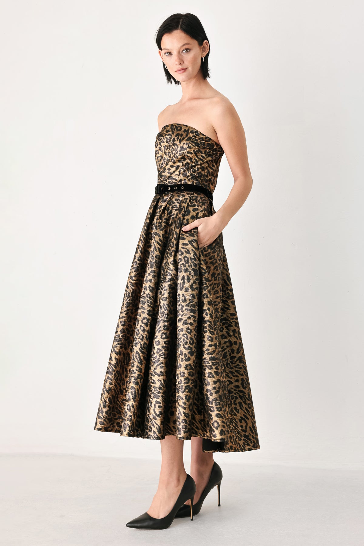 A woman modeling a strapless leopard-print midi dress with a black waist belt | FREEMARKET