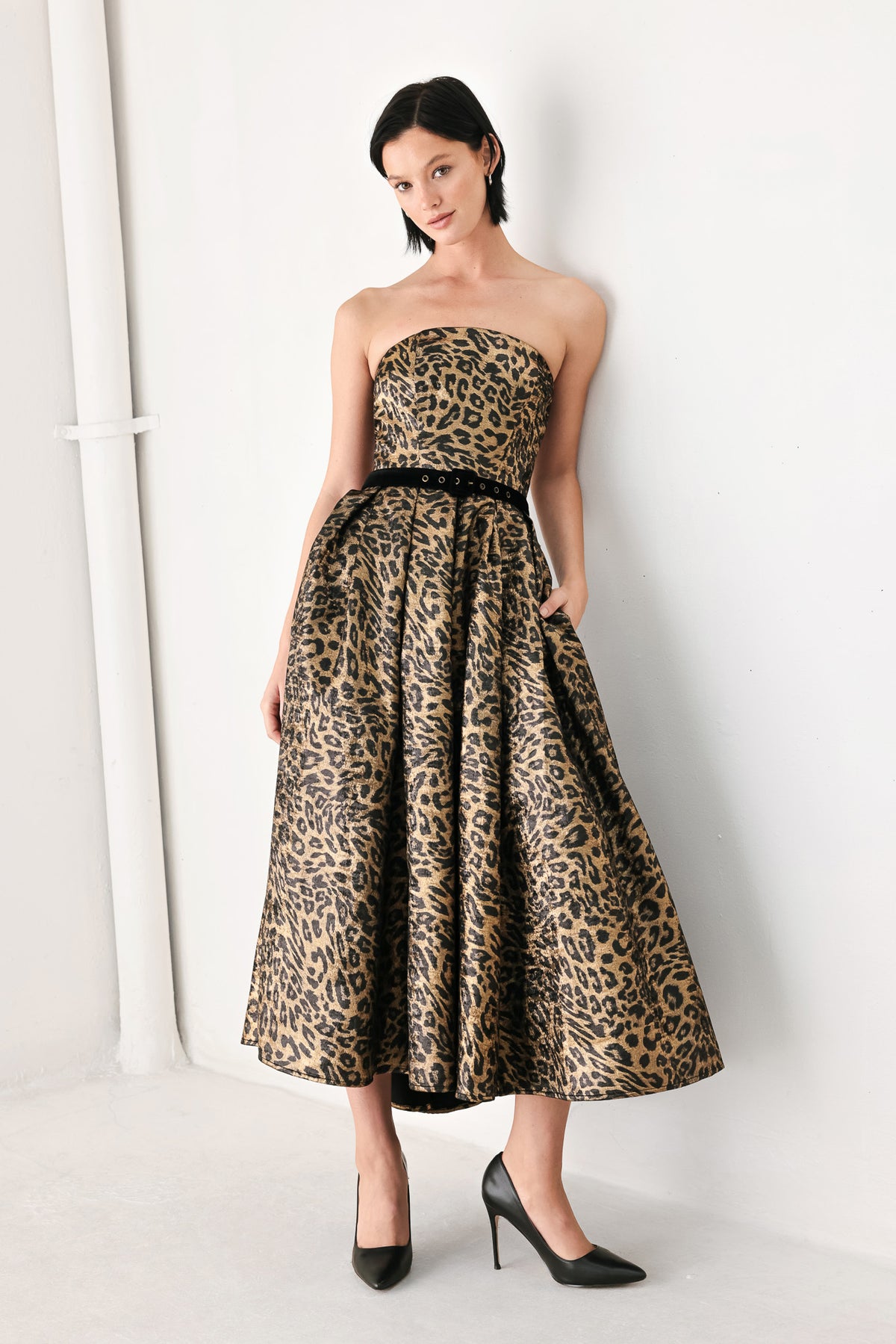 A woman modeling a strapless leopard-print midi dress with a black waist belt | FREEMARKET