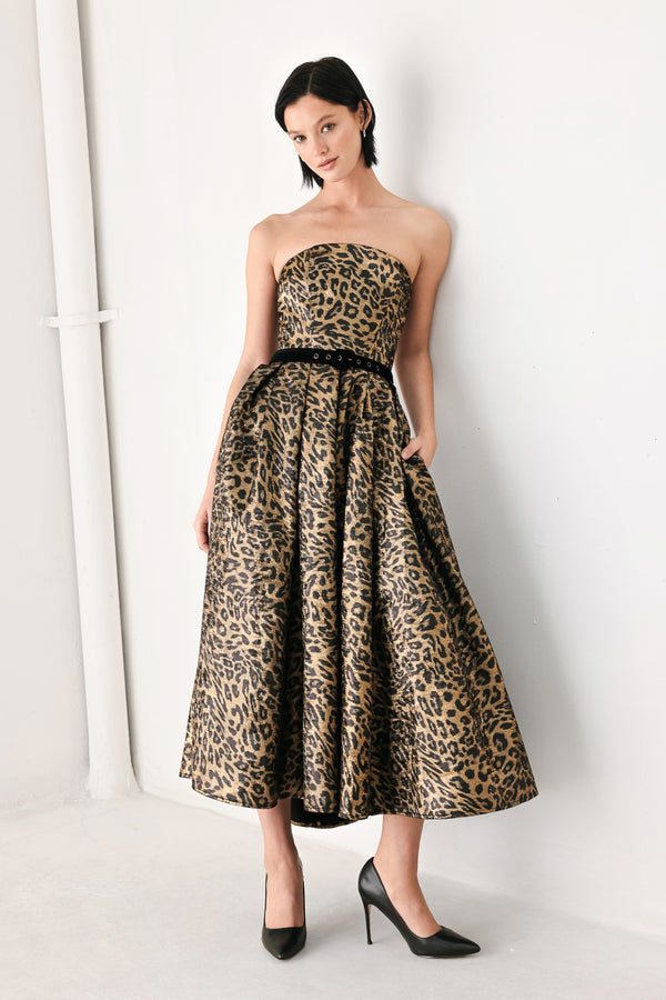 A woman modeling a strapless leopard-print midi dress with a black waist belt | FREEMARKET