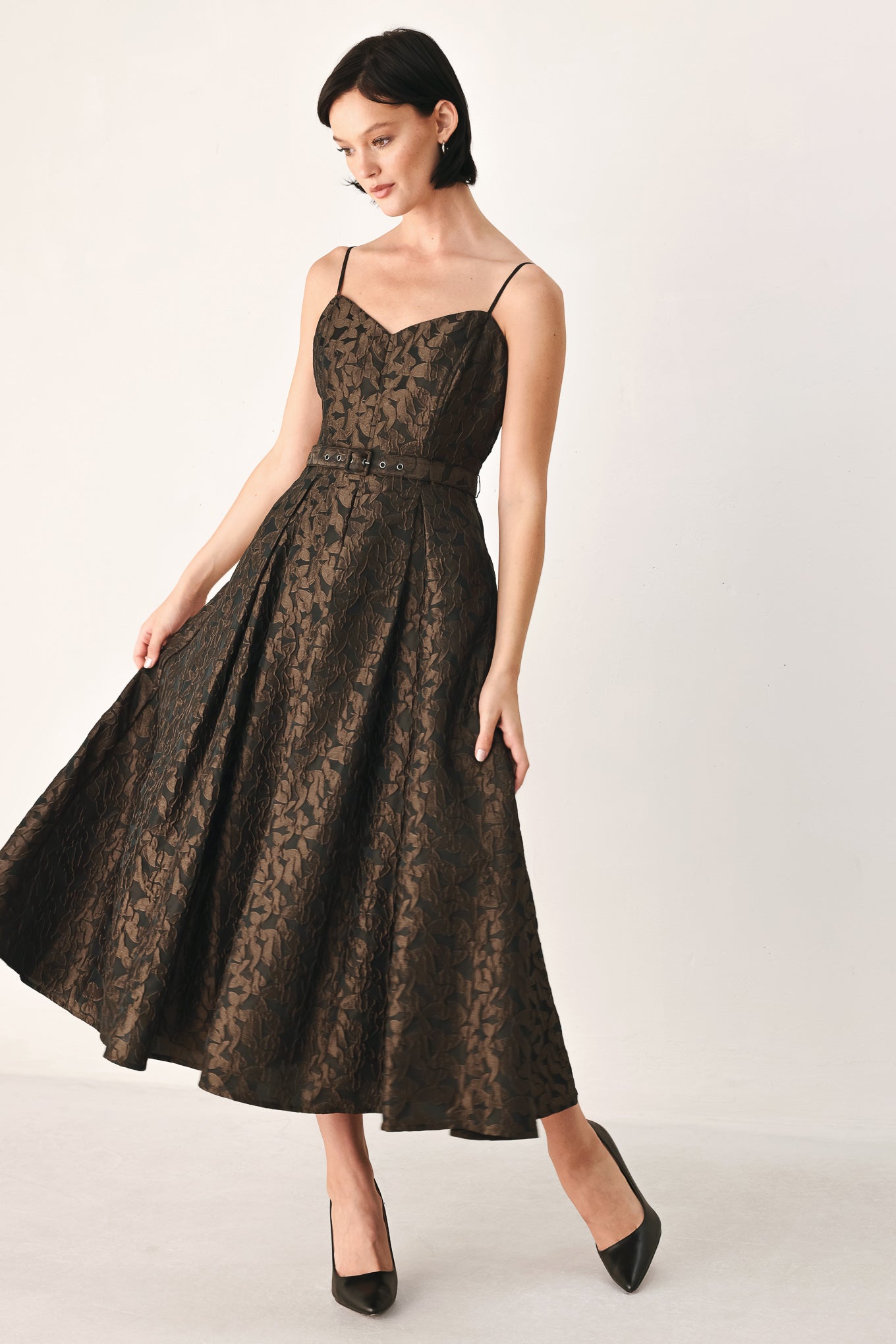 A woman modeling a sleeveless midi dress with thin straps, a sweetheart neckline, and a fitted waist. The dress has an allover dark brown and black floral jacquard pattern | FREEMARKET