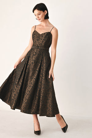 A woman modeling a sleeveless midi dress with thin straps, a sweetheart neckline, and a fitted waist. The dress has an allover dark brown and black floral jacquard pattern | FREEMARKET