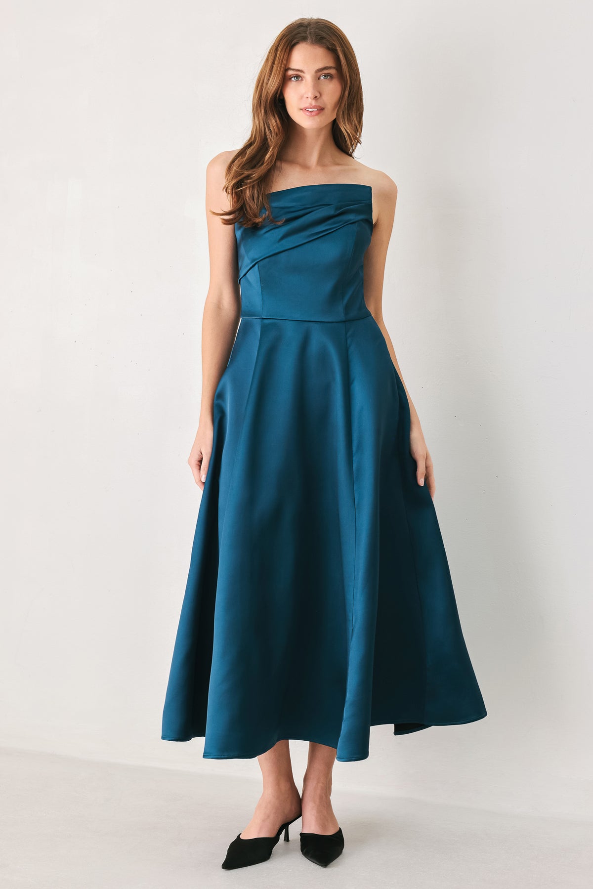 Woman wearing a strapless satin-like teal midi dress with asymmetrical neckline | FREEMARKET