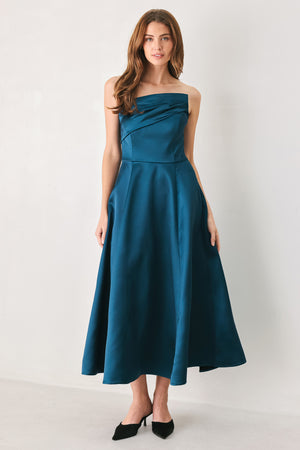 Woman wearing a strapless satin-like teal midi dress with asymmetrical neckline | FREEMARKET