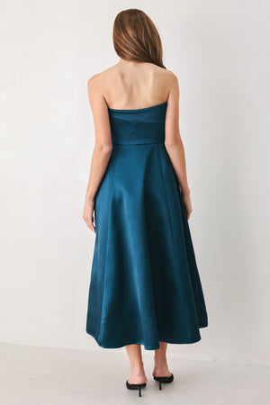 Woman wearing a strapless satin-like teal midi dress with asymmetrical neckline | FREEMARKET