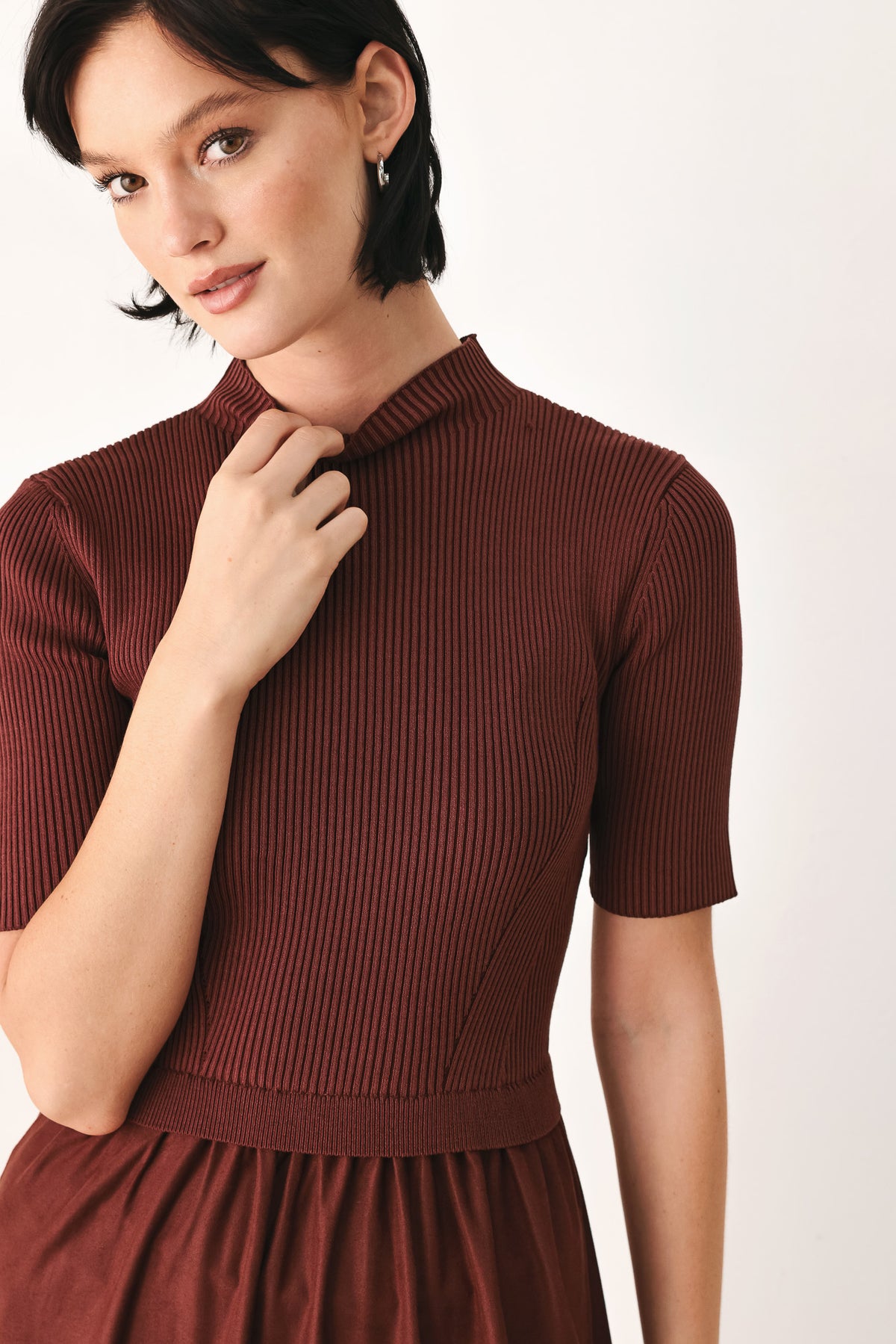 A woman modeling a rust-brown tiered midi dress with short sleeves and a mock neck | FREEMARKET