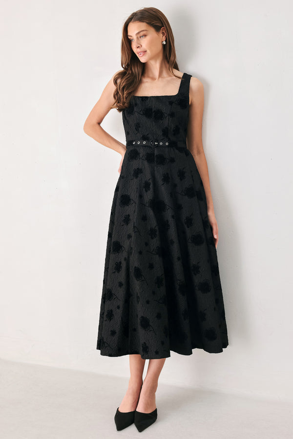 Woman wearing a sleeveless, square neckline black midid dress with jacquard floral pattern and slim waist belt | FREEMARKET 
