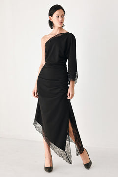 A model wearing a black one-shoulder midi dress with lace trim on the sleeve and hem | FREEMARKET