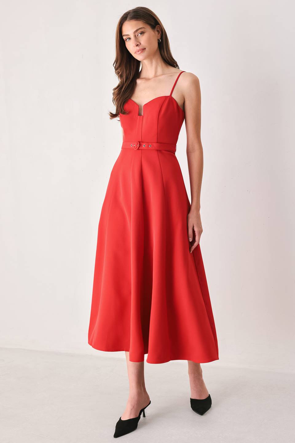 Woman wearing a red spaghetti strap midi dress with a sweetheart neckline and matching thin waist belt | FREEMARKET