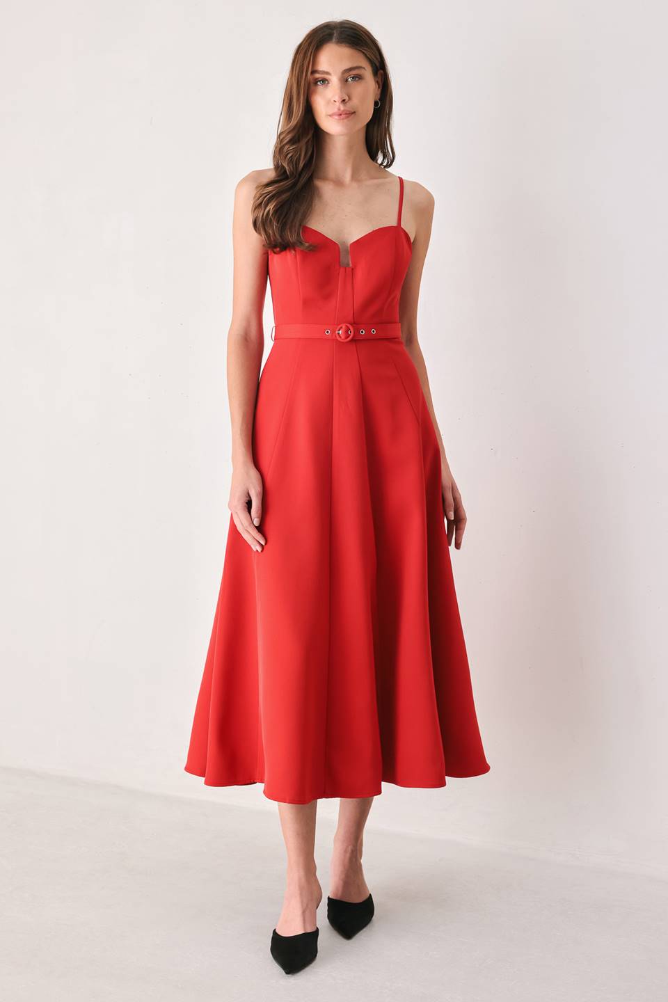 Woman wearing a red spaghetti strap midi dress with a sweetheart neckline and matching thin waist belt | FREEMARKET