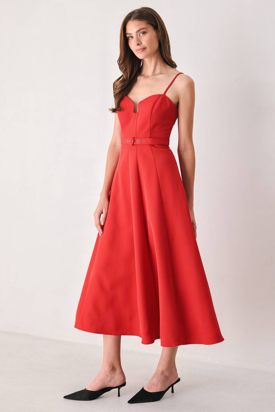 Woman wearing a red spaghetti strap midi dress with a sweetheart neckline and matching thin waist belt | FREEMARKET